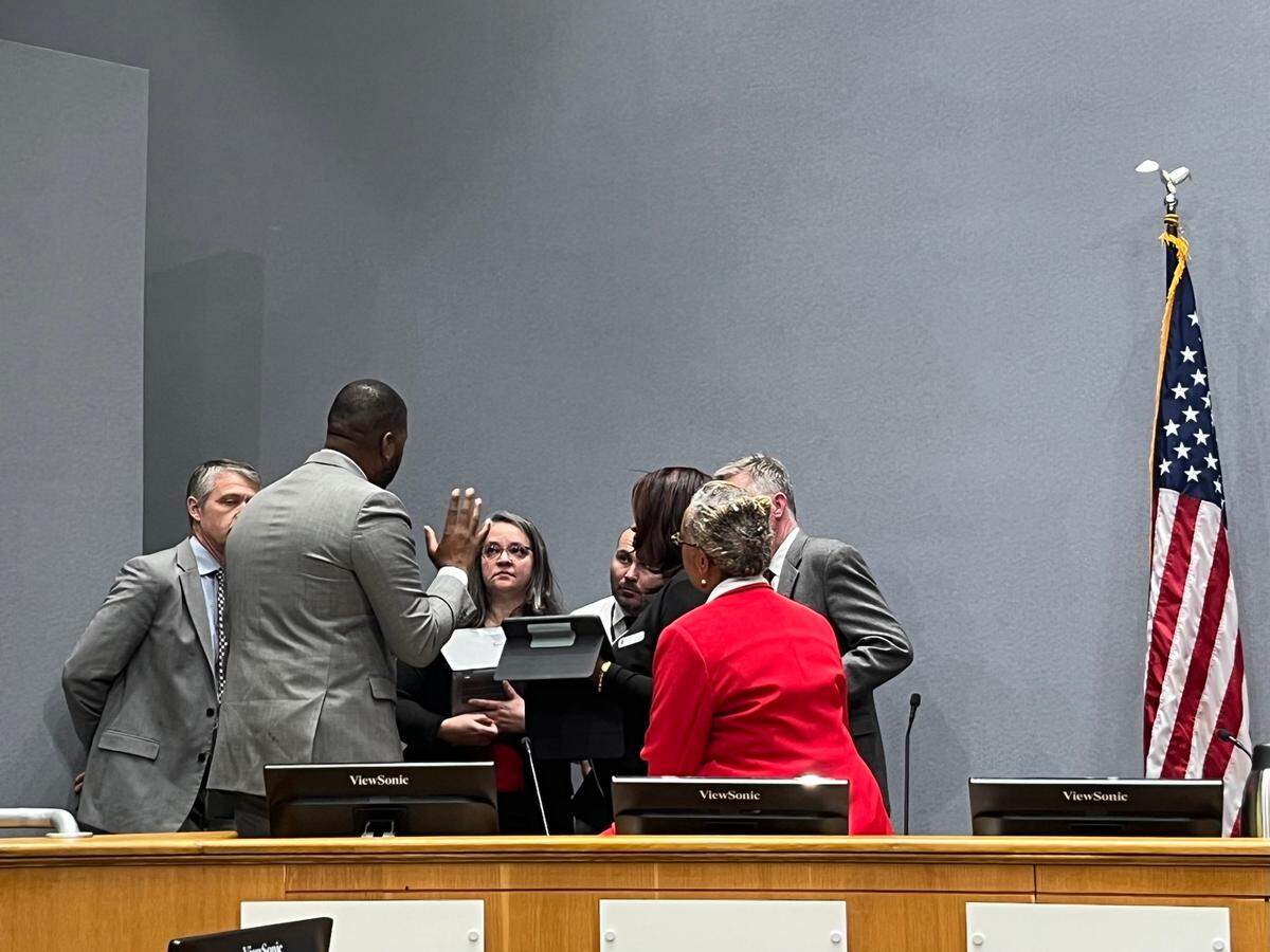 Durham leaders discuss SCAD during a break in the Nov. 20, 2023 meeting. From left, deputy city manager Bo Ferguson, City Council member Leonardo Williams, planning director Sara Young, assistant planning director Bo Dobrzenski, City Council member DeDreana Freeman, Mayor Elaine O’Neal and deputy city attorney Don O’Toole.