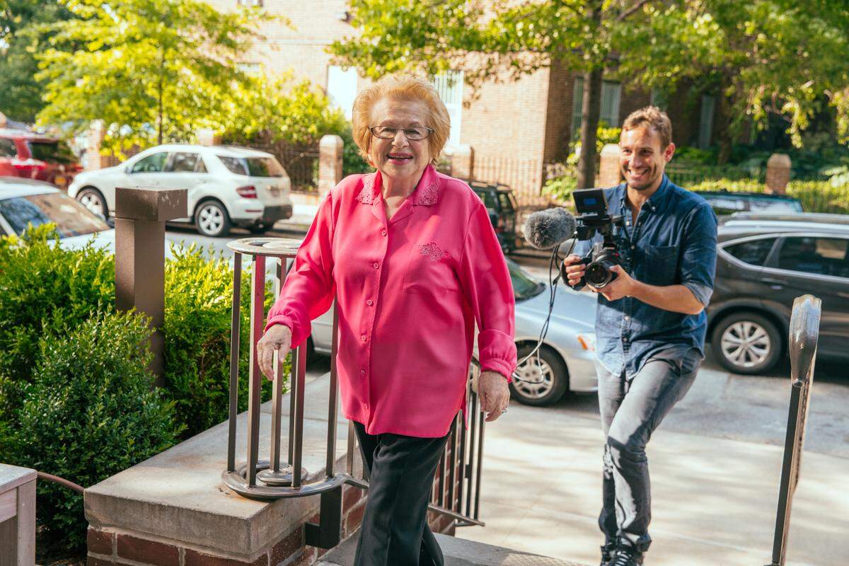 Ask Dr. Ruth chronicles the incredible life of Dr. Ruth Westheimer, a Holocaust survivor who became America’s most famous sex therapist. With her diminutive frame, thick German accent, and uninhibited approach to sex therapy and education, Dr. Ruth transformed the conversation around sexuality. As she approaches her 90th birthday and shows no signs of slowing down, Dr. Ruth revisits her painful past and unlikely path to a career at the forefront of the sexual revolution. Dr. Ruth and director, Ryan White shown. (Photo by: Austin Hargrave)
