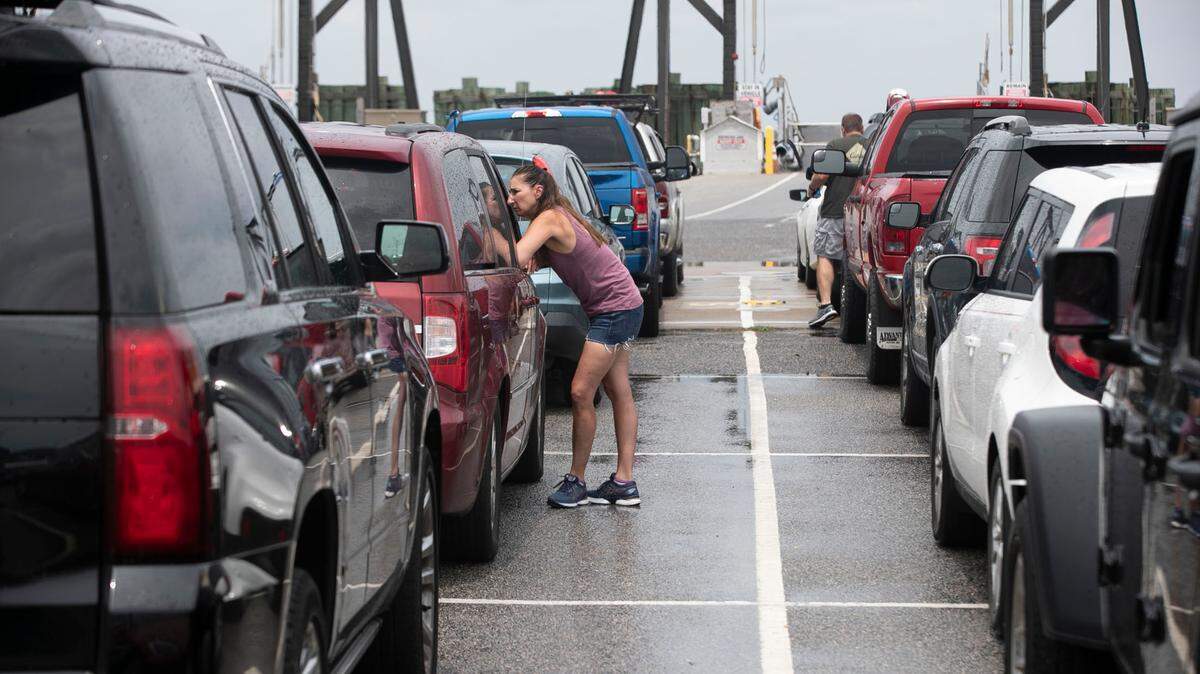 Passengers wait in line to board the ferry from Hatteras to Ocracoke on July 21, 2021.