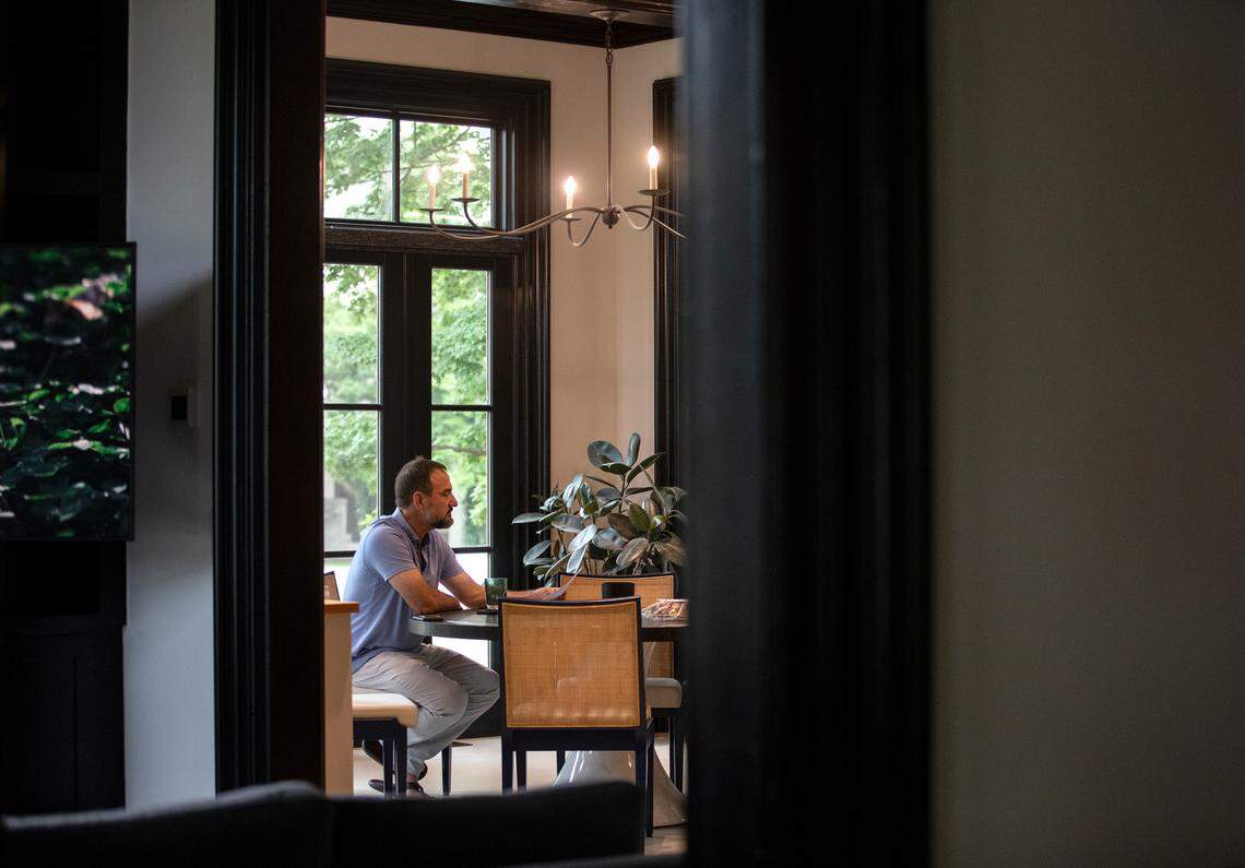 Jeff Turpin sits at a table as dinner is prepared on Thursday, May 25, 2023, at the Andrews-Duncan House in Raleigh, N.C.