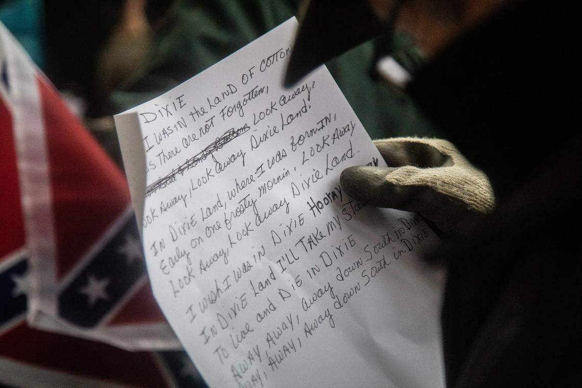 A pro-Confederate protester looks over the lyrics to “Dixie” before engaging with anti-racist protesters in a roving shouting match around UNC Chapel-Hill campus and Franklin Street in Chapel Hill, Saturday, Feb. 23, 2019. Despite some shoving and a brief tug-of-war over a Confederate flag, there were no arrests and there appeared to be no injuries.