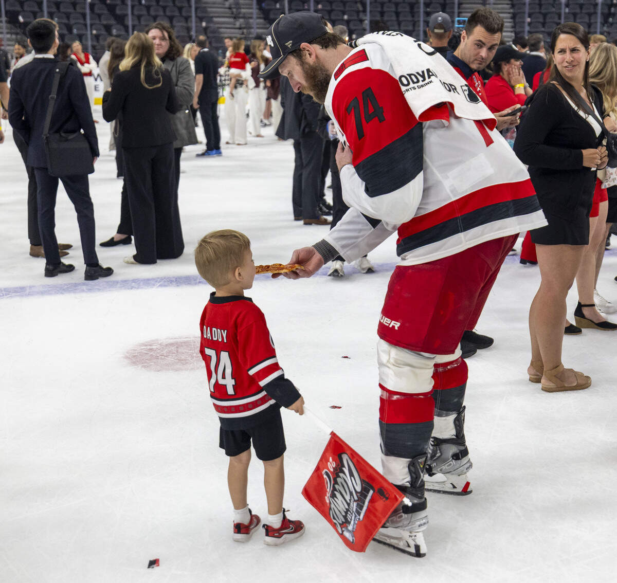 Carolina Hurricanes defenseman Jacoob Slavin (74) offers his son Charlie, a bite of pizza, during the post game Stanley Cup celebration on Sunday, June 14, 2026 at T-Mobile Arena in Las Vegas, NV.