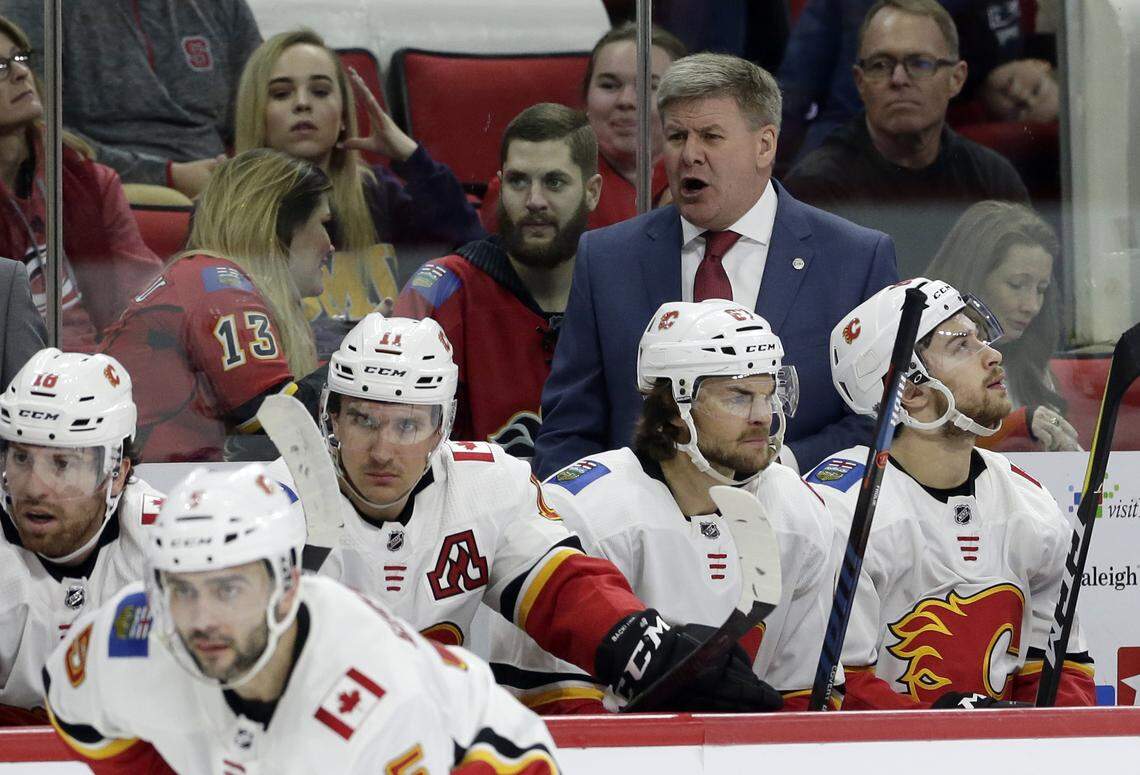 Calgary Flames head coach Bill Peters reacts during the second period of an NHL hockey game against the Carolina Hurricanes in Raleigh, N.C., Sunday, Feb. 3, 2019. (AP Photo/Gerry Broome)
