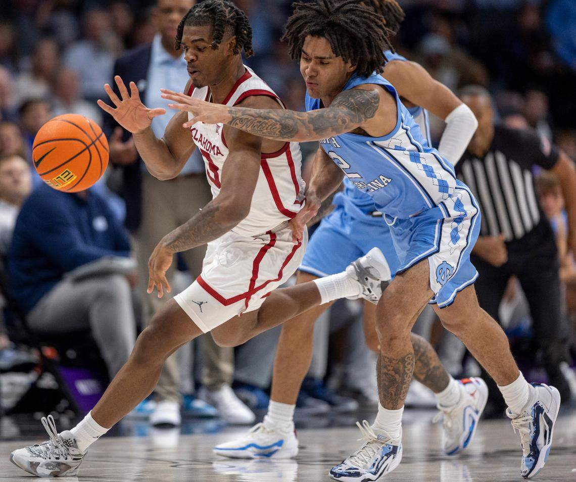 North Carolina’s Elliot Cadeau (2) works for a steal from Oklahoma’s Otega Oweh (3) in the second half on Wednesday, December 20, 2023 at the Spectrum Center in Charlotte, N.C.