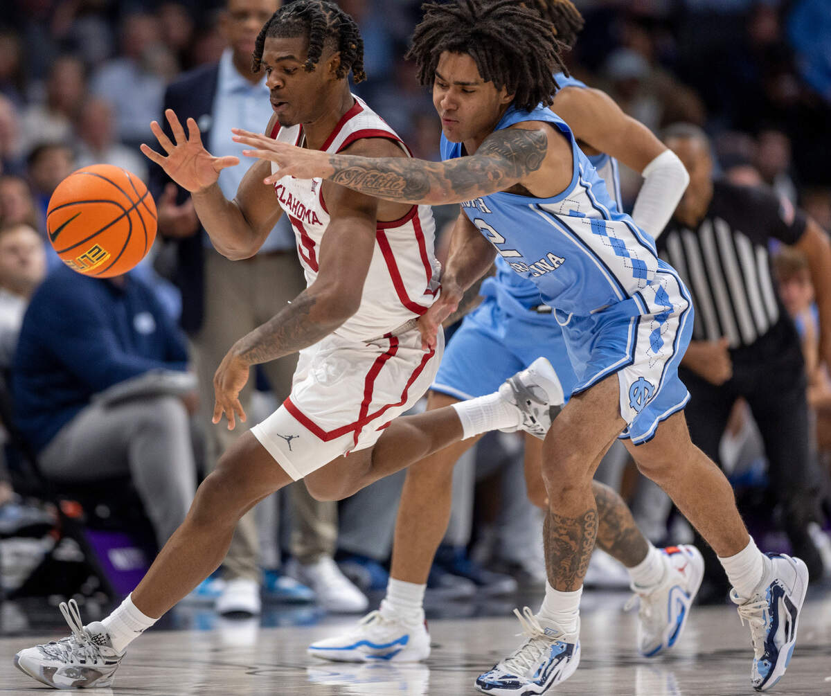 North Carolina’s Elliot Cadeau (2) works for a steal from Oklahoma’s Otega Oweh (3) in the second half on Wednesday, December 20, 2023 at the Spectrum Center in Charlotte, N.C.
