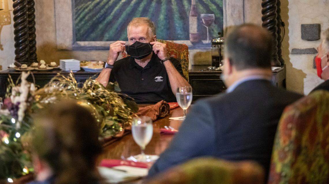 Sen. Thom Tillis demonstrates both effective and ineffective ways to wear a face covering while leading a roundtable discussion on the Paycheck Protection Program with members of the restaurant and hospitality industry Tuesday, Aug. 25, 2020 at the Angus Barn in Raleigh. Tillis says he has been a proponent of wearing face masks since the CDC recommended the practice in April.