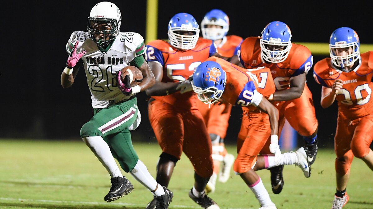 Joshua Hullum (26) of Green Hope scores a touchdown against the defense from Adam Braden (20), AJ Harris (52) and Aaron Boyce-Cooley (66) of Athens Drive. The Green Hope Falcons visited the Athens Drive Jaguars in a high school football game on October 15, 2018.