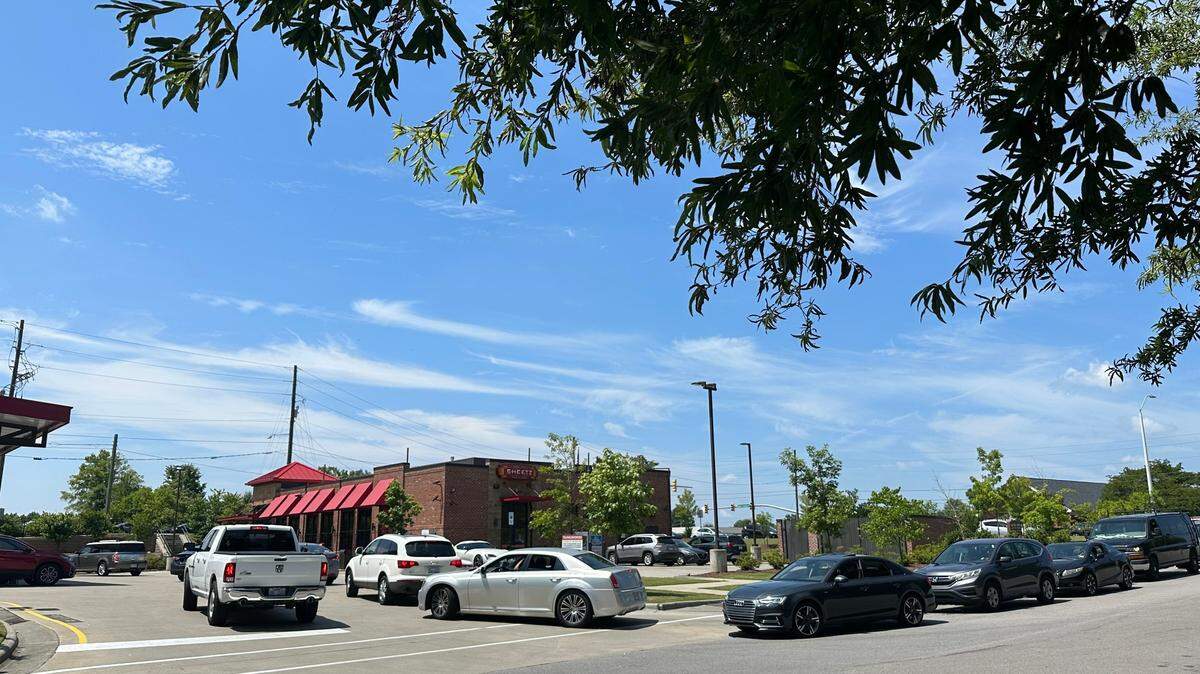 Customers line up to get discounted gas at a Sheetz in Cary on July 4