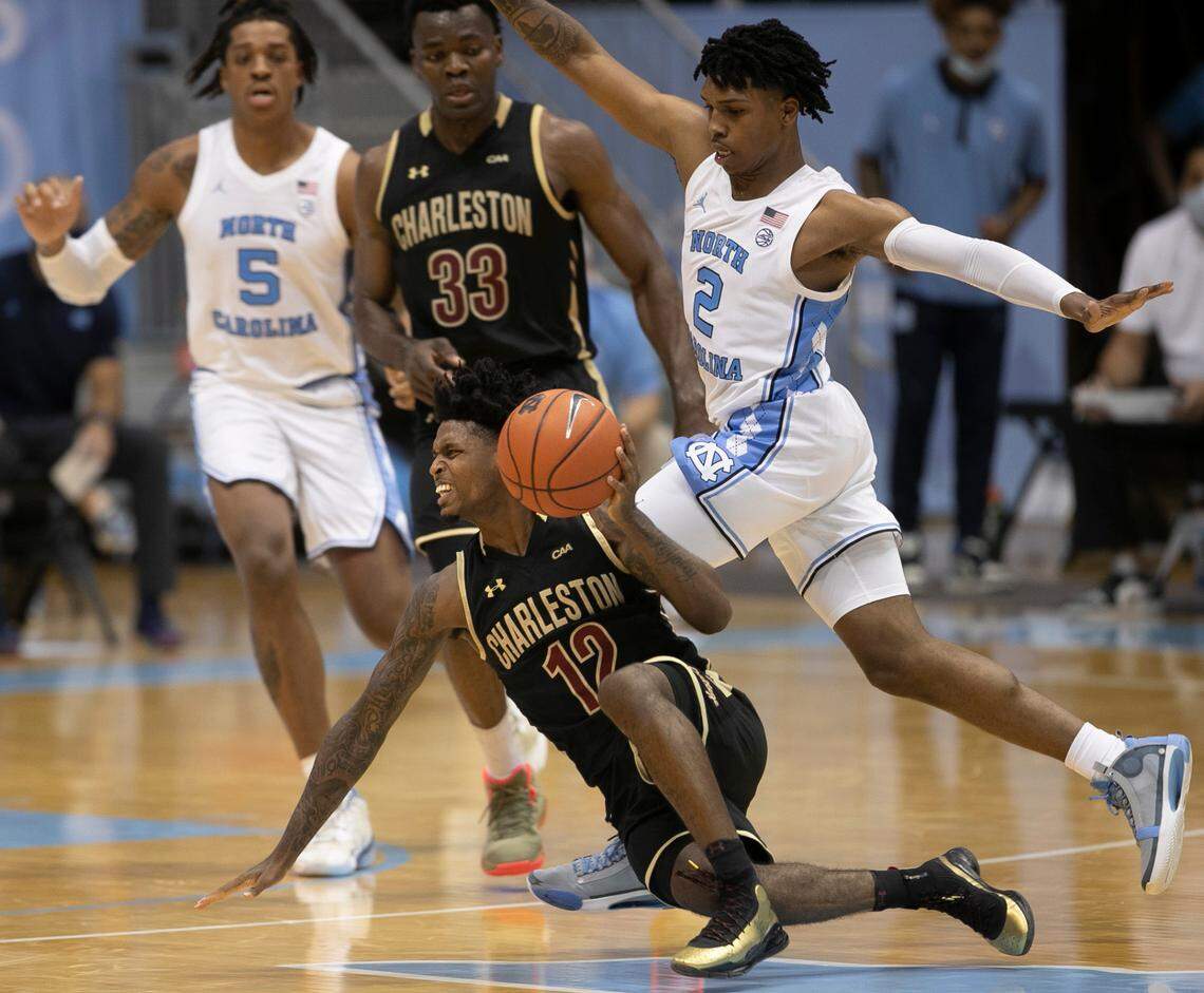 North Carolina’s Caleb Love (2) defends College of Charleston’s Zep Jasper (12) defense during the first half on Wednesday, November 25, 2020 at the Smith Center in Chapel Hill, N.C.
