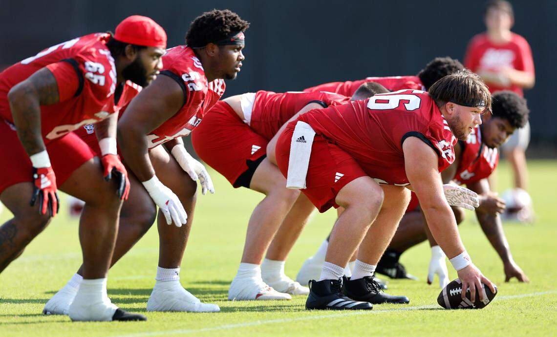 Members of the N.C. State offensive line, from left, Jacarrius Peak (65), Timothy McKay (52) and Zeke Correll (56) run a drill during the Wolfpack’s first practice in Raleigh, N.C., Wednesday, July 31, 2024.