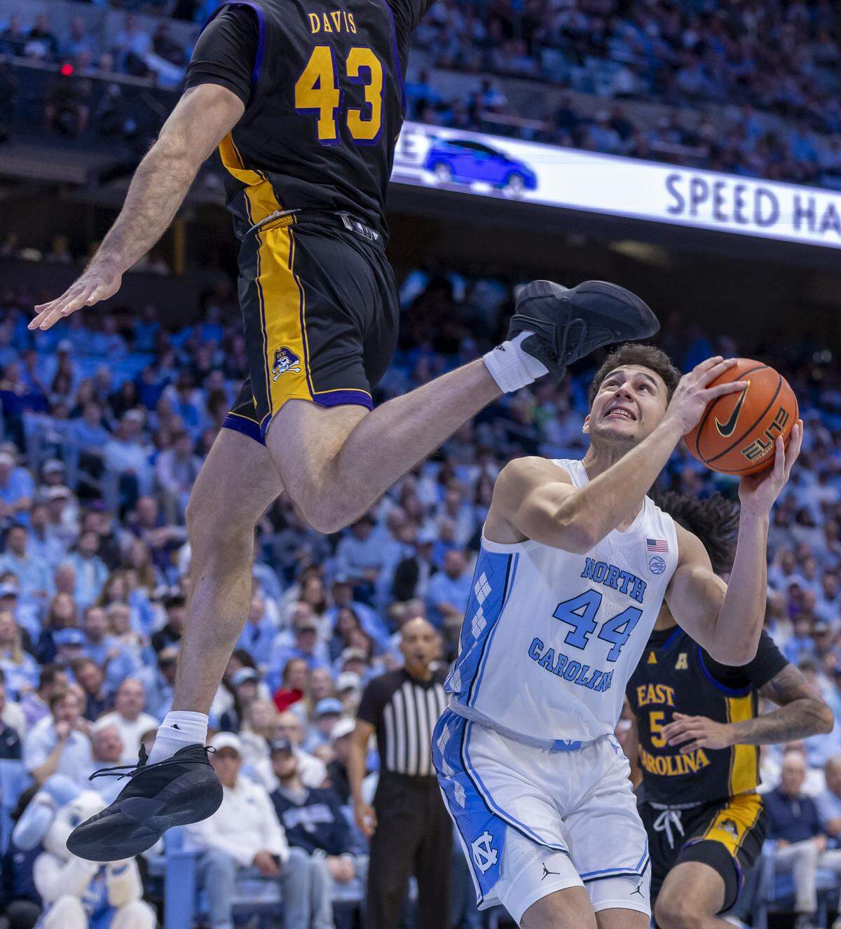 East Carolina forward Luke Davis (43) defends North Carolina guard Luka Bogavac (44) in the first half on Monday, December 22, 2025 at the Smith Center in Chapel Hill, N.C.