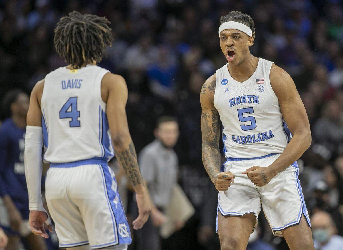 North Carolina’s Armando Bacot (5) and R.J. Davis (4) react after securing a lead over Saint Peter’s in the first half during the NCAA East Regional final on Sunday, March 27, 2022 at Wells Fargo Center in Philadelphia, Pa.