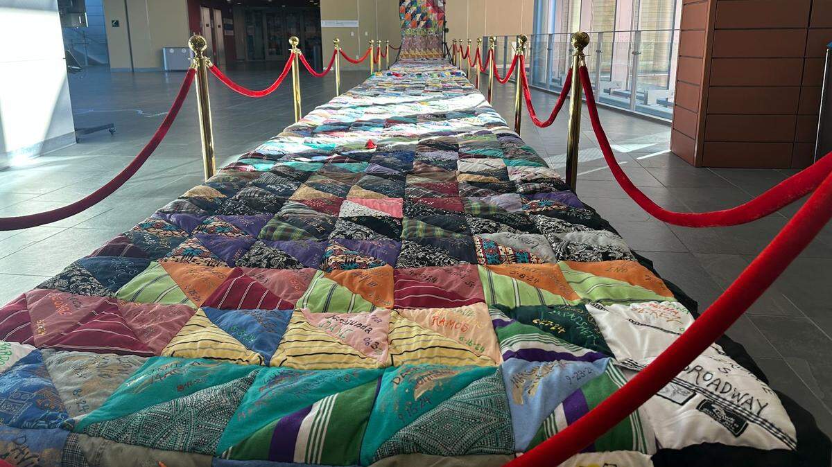A quilt displaying the names of every person killed in a homicide in Durham since 1994 sits on the second floor of the Durham County Human Services building on Dec. 23, 2024. Artist Sidney Brodie began the quilt in 1996 to call attention to gun violence in the community.