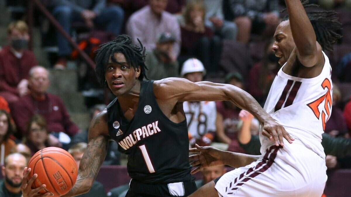North Carolina State’s Dereon Seabron (1) drives past Virginia Tech’s Justyn Mutts (25) in the first half of an NCAA college basketball game Tuesday, Jan. 4, 2022, in Blacksburg, Va. (Matt Gentry/The Roanoke Times via AP)