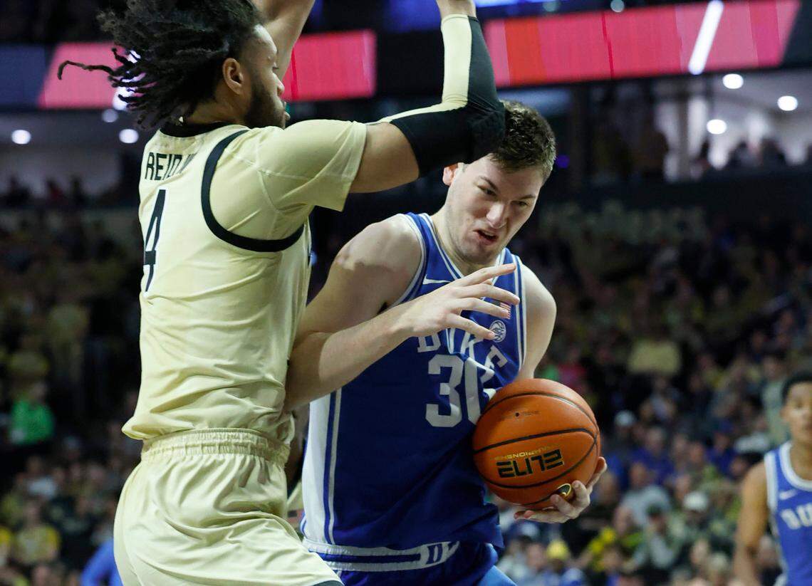Duke’s Kyle Filipowski (30) tries to work around Wake Forest’s Efton Reid III (4) during the first half of Duke’s game against Wake Forest at Lawrence Joel Veterans Memorial Coliseum in Winston-Salem, N.C., Saturday, Feb. 24, 2024.