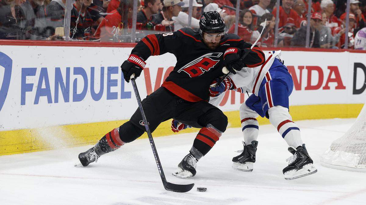 Carolina's William Carrier (28) works his way around Montréal's Lane Hutson (48) during the first period of the Hurricanes’ game against the Canadiens in game one of the Eastern Conference Finals at the Lenovo Center Thursday, May, 21, 2026.