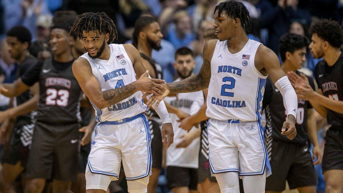 North Carolina’s Caleb Love (2) congratulates R.J. Davis (4) after a three point basket by Davis during the second half against Brown on Friday, November 12, 2021 at the Smith Center in Chapel Hill, N.C.