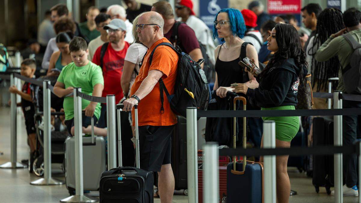 Passengers wait in Terminal 2 at Raleigh-Durham International Airport on Friday, July 19, after a worldwide computer outage traced to a software update by the cybersecurity company CrowdStrike caused numerous canceled and delayed flights.
