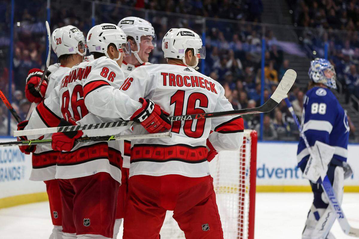 Carolina Hurricanes’ Teuvo Teravainen (86), of Finland, celebrates his goal with teammates, including Vincent Trocheck, as Tampa Bay Lightning goaltender Andrei Vasilevskiy, of Russia, reacts during the third period of an NHL hockey game Tuesday, Nov. 9, 2021, in Tampa, Fla. The Hurricanes won 2-1. (AP Photo/Mike Carlson)