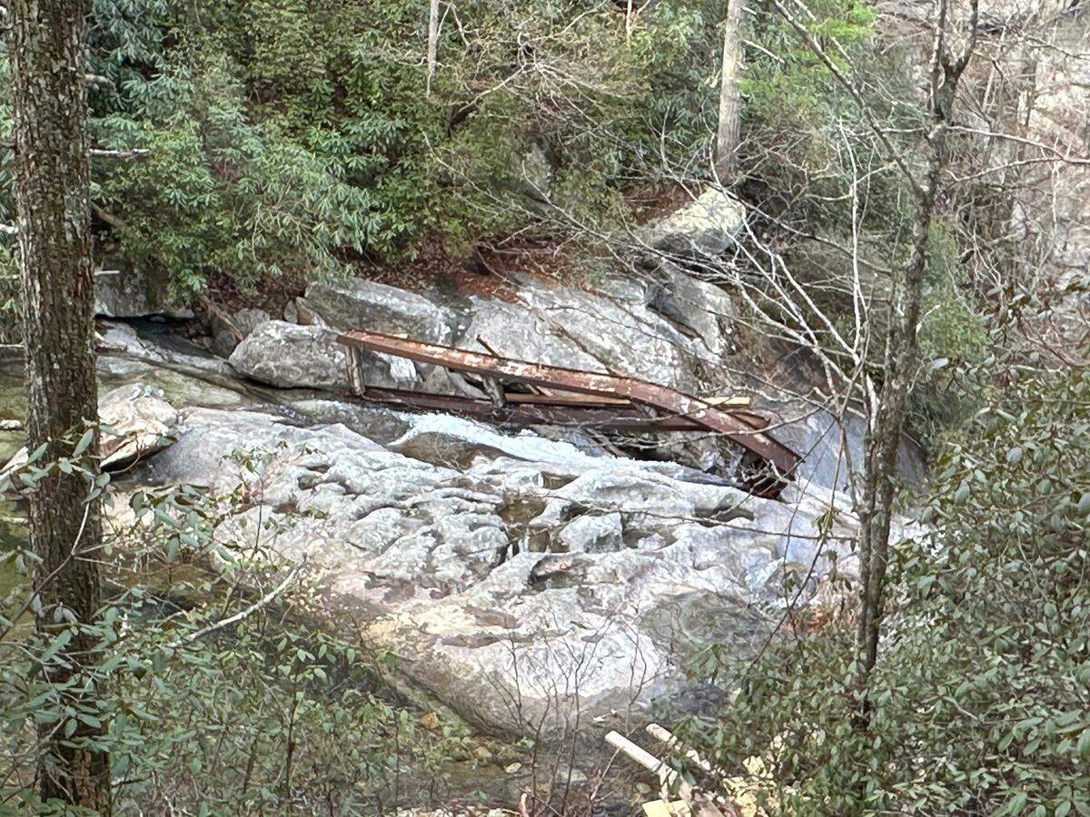 The steel frame of a bridge stuck atop High Shoals Falls in South Mountains State Park. The bridge was swept away when the remnants of Hurricane Helene caused flooding in the park in late September.