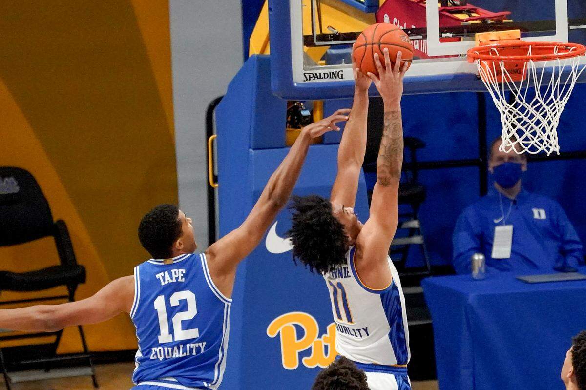 Pittsburgh’s Justin Champagnie (11) dunks after getting by Duke’s Patrick Tape (12) during the first half of an NCAA college basketball game, Tuesday, Jan. 19, 2021, in Pittsburgh.