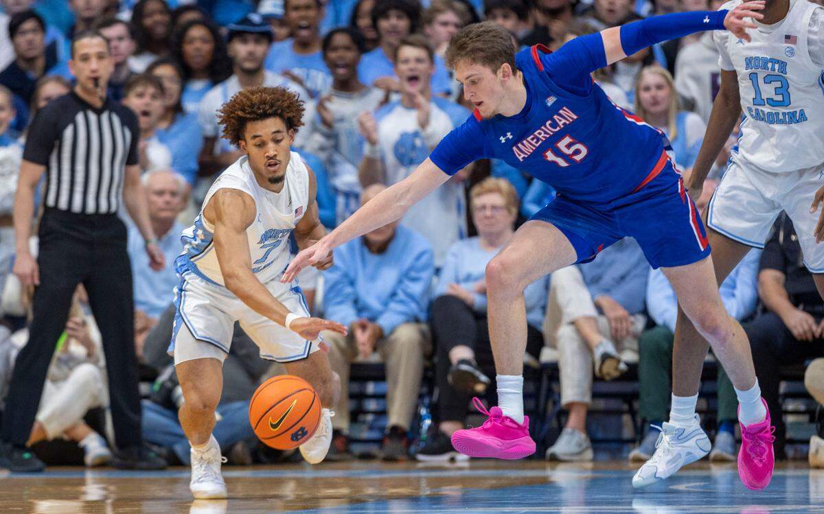 North Carolina guard Seth Trimble (7) makes a steal from American University forward Matt Rogers (15) in the first half on Friday, November 15, 2024 at the Smith Center in Chapel Hill, N.C.