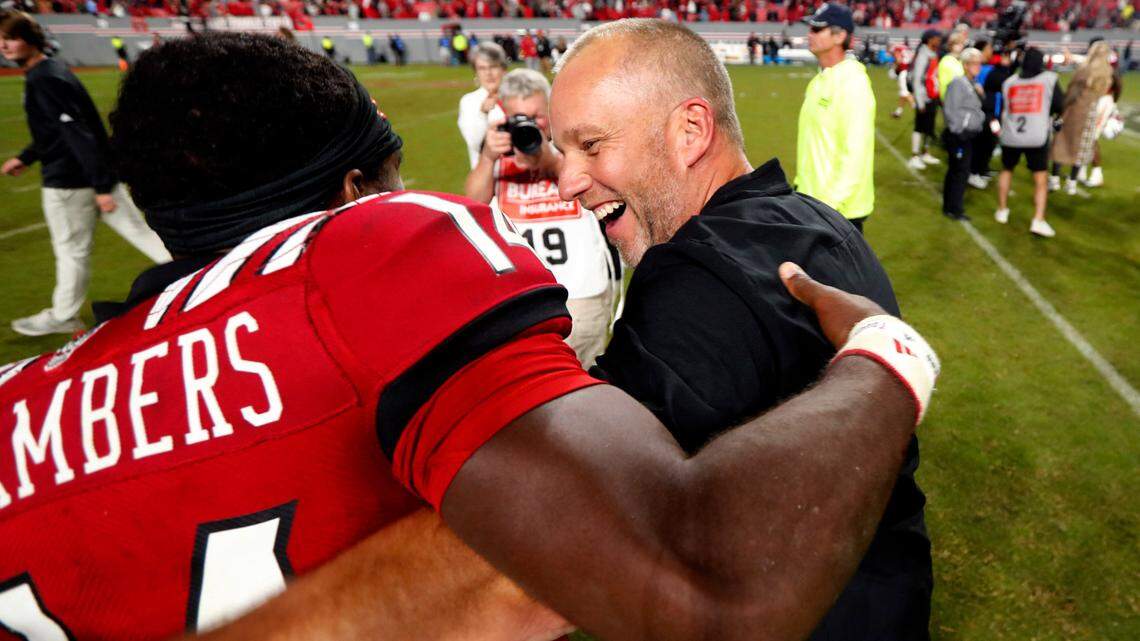 N.C. State head coach Dave Doeren celebrates with quarterback Jack Chambers (14) after N.C. State’s 19-17 victory over Florida State at Carter-Finley Stadium in Raleigh, N.C., Saturday, Oct. 8, 2022.