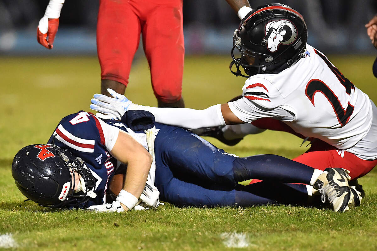 Apex Friendship wide receiver  Adam Schreiber (4) protects the ball from Rolesville defensive back Jordin Michael (24) during the first half. The Apex Friendship Patriots and the Rolesville Rams met in  the second round of the  NCHSAA 8A Playoff game in Apex, N.C. on November 14, 2025. Rolesville wins 14-7 in overtime.