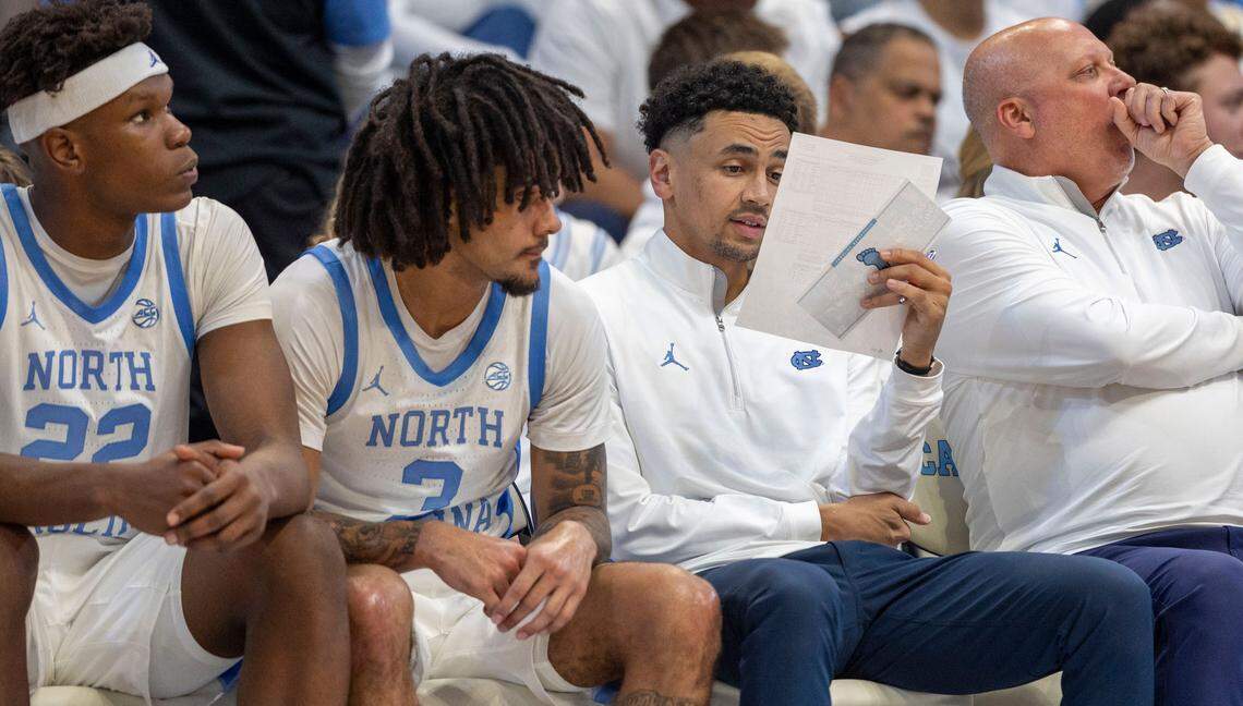 North Carolina assistant coach Marcus Paige studies a stat sheet during the final time out in the second half against Alabama on Wednesday, December 4, 2024 at the Smith Center in Chapel Hill, N.C. Alabama rolled to a 94-79 victory.