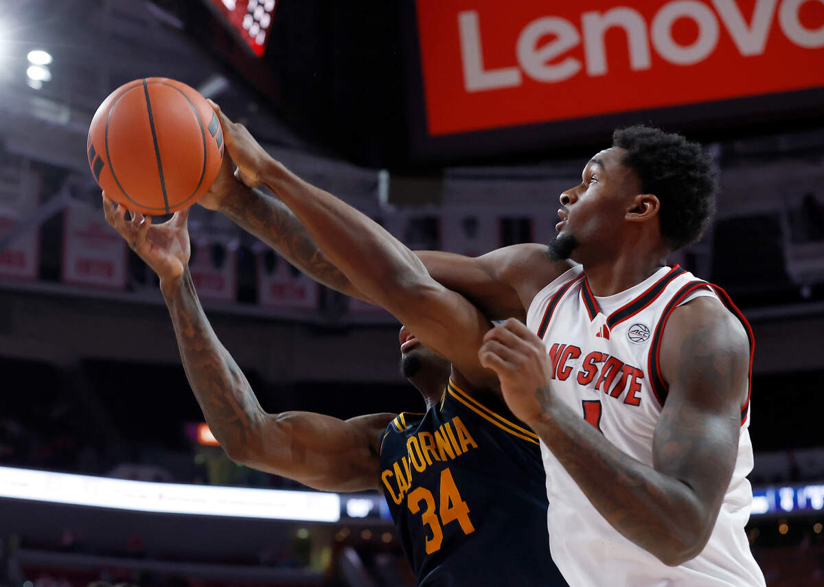 California’s Lee Dort and N.C. State’s Brandon Huntley-Hatfield battle for a rebound during the first half of the Wolfpack’s game on Saturday, Jan. 18, 2025, at Lenovo Center in Raleigh, N.C.