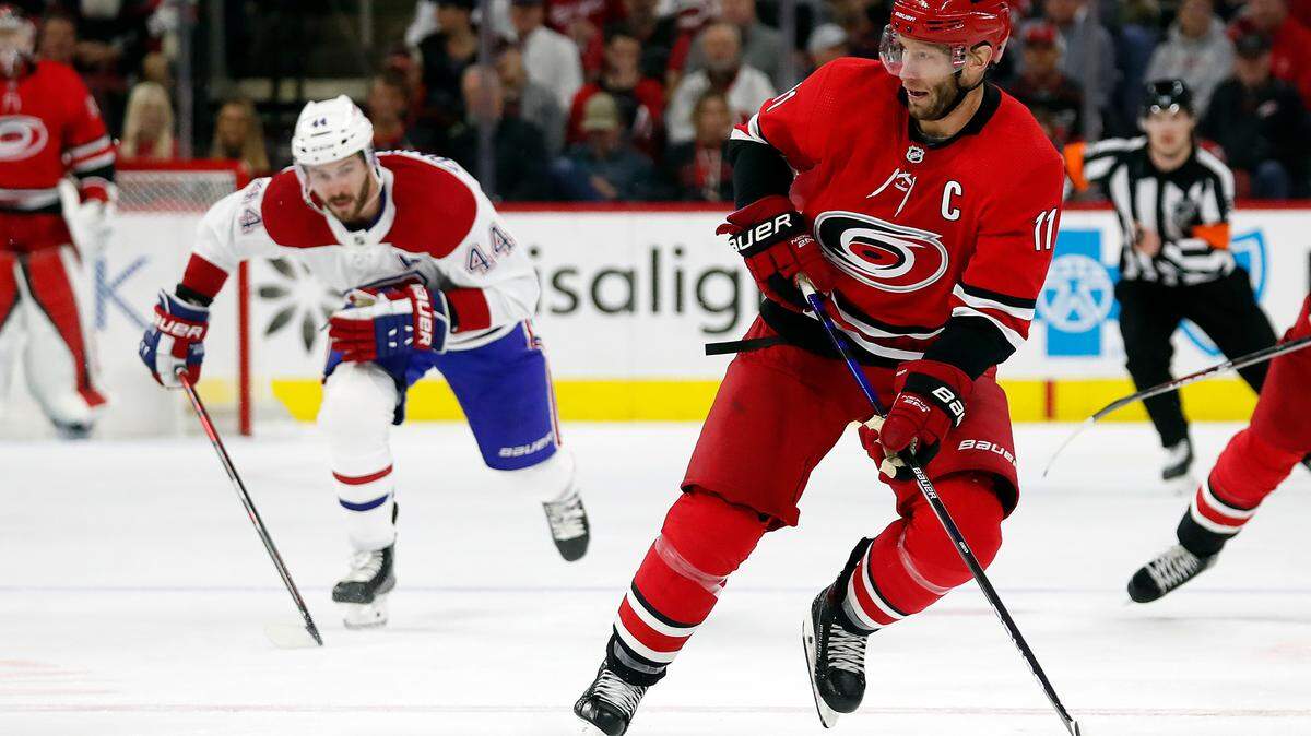 Carolina Hurricanes’ Jordan Staal (11) controls the puck in front of Montreal Canadiens’ Joel Edmundson (44) during the second period of an NHL hockey game in Raleigh, N.C., Thursday, March 31, 2022. (AP Photo/Karl B DeBlaker)