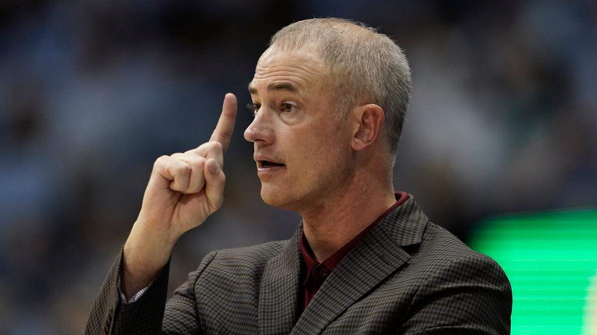 Elon head coach Mike Schrage signals his players during the second half of an NCAA college basketball game against North Carolina in Chapel Hill, N.C., Saturday, Dec. 11, 2021.
