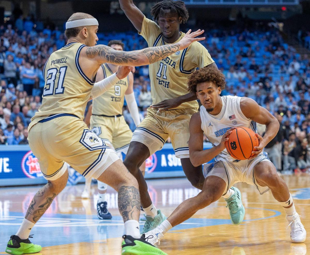 Georgia Tech’s Duncan Powell (31) and Baye Nidongo (11) trap North Carolina guard Seth Trimble (7) in the second half on Saturday, December 7, 2024 at the Smith Center in Chapel Hill, N.C.