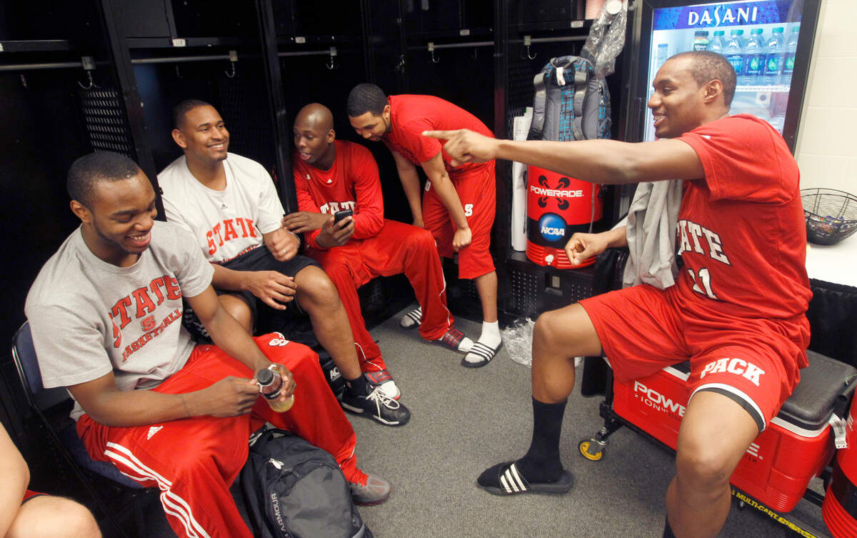 N.C. State assistant director of operations Levi Watkins, second from left, laughs with Patrick Johnson, DeShawn Painter, Jay Lewis and C.J. Williams after practice at Nationwide Arena in Columbus, Ohio in March 2012.