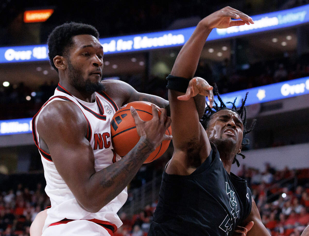 N.C. State’s Brandon Huntley-Hatfield grabs a rebound away from William & Mary’s Gabe Dorsey during the first half of the Wolfpack’s 84-61 win at Lenovo Center on Friday, Nov. 22, 2024, in Raleigh, N.C.