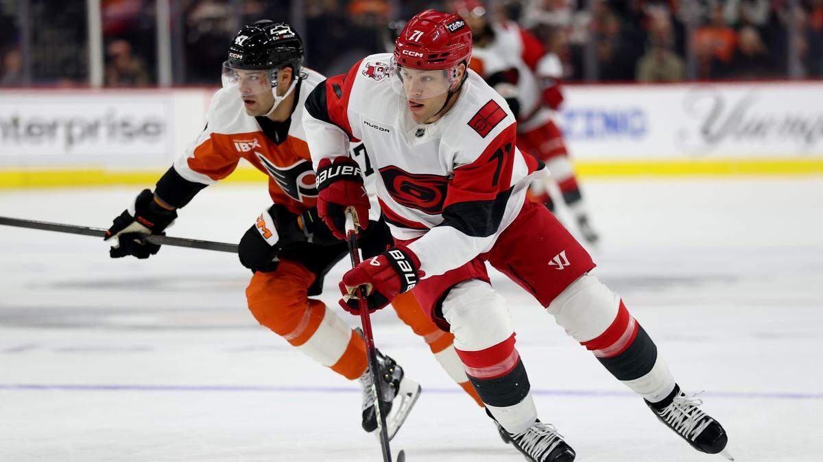 Taylor Hall of the Carolina Hurricanes controls the puck during the first period against the Philadelphia Flyers at Xfinity Mobile Arena on Dec. 13, 2025 in Philadelphia, Pennsylvania.