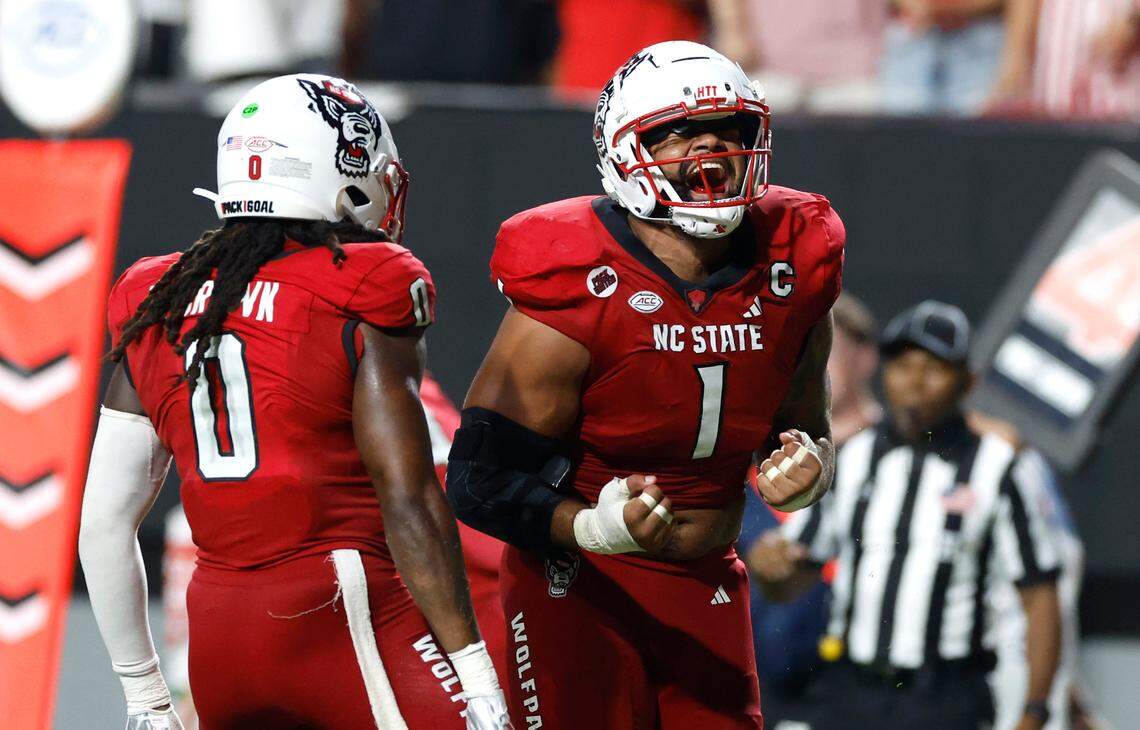 N.C. State linebacker Sean Brown (0) celebrates with defensive end Davin Vann (1) after Western Carolina was stopped for a loss during the second half of N.C. State’s 38-21 victory over Western Carolina at Carter-Finley Stadium in Raleigh, N.C., Thursday, August 29, 2024.