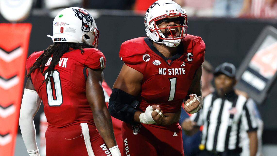 N.C. State linebacker Sean Brown (0) celebrates with defensive end Davin Vann (1) after Western Carolina was stopped for a loss during the second half of N.C. State’s 38-21 victory over Western Carolina at Carter-Finley Stadium in Raleigh, N.C., Thursday, August 29, 2024.