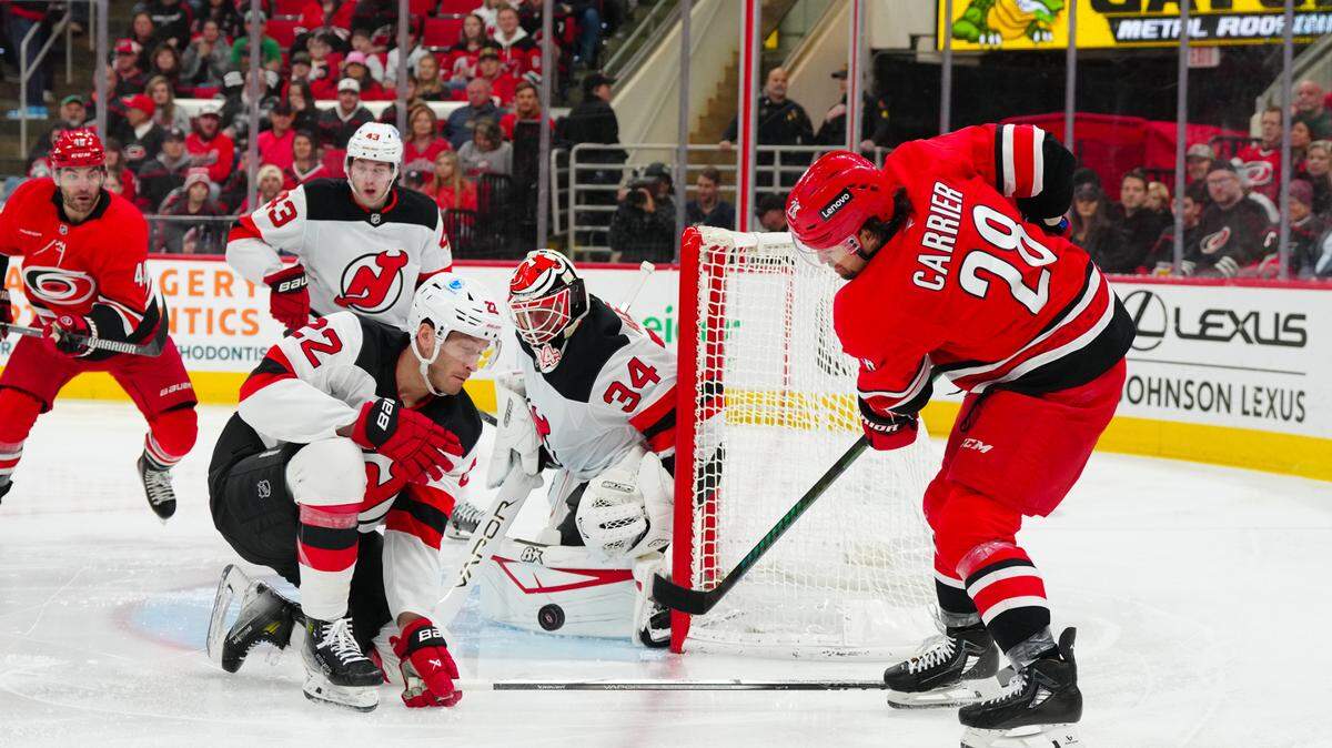 Carolina Hurricanes left wing William Carrier (28) takes a shot at New Jersey Devils defenseman Brett Pesce (22) and goaltender Jake Allen (34) during the first period at Lenovo Center.