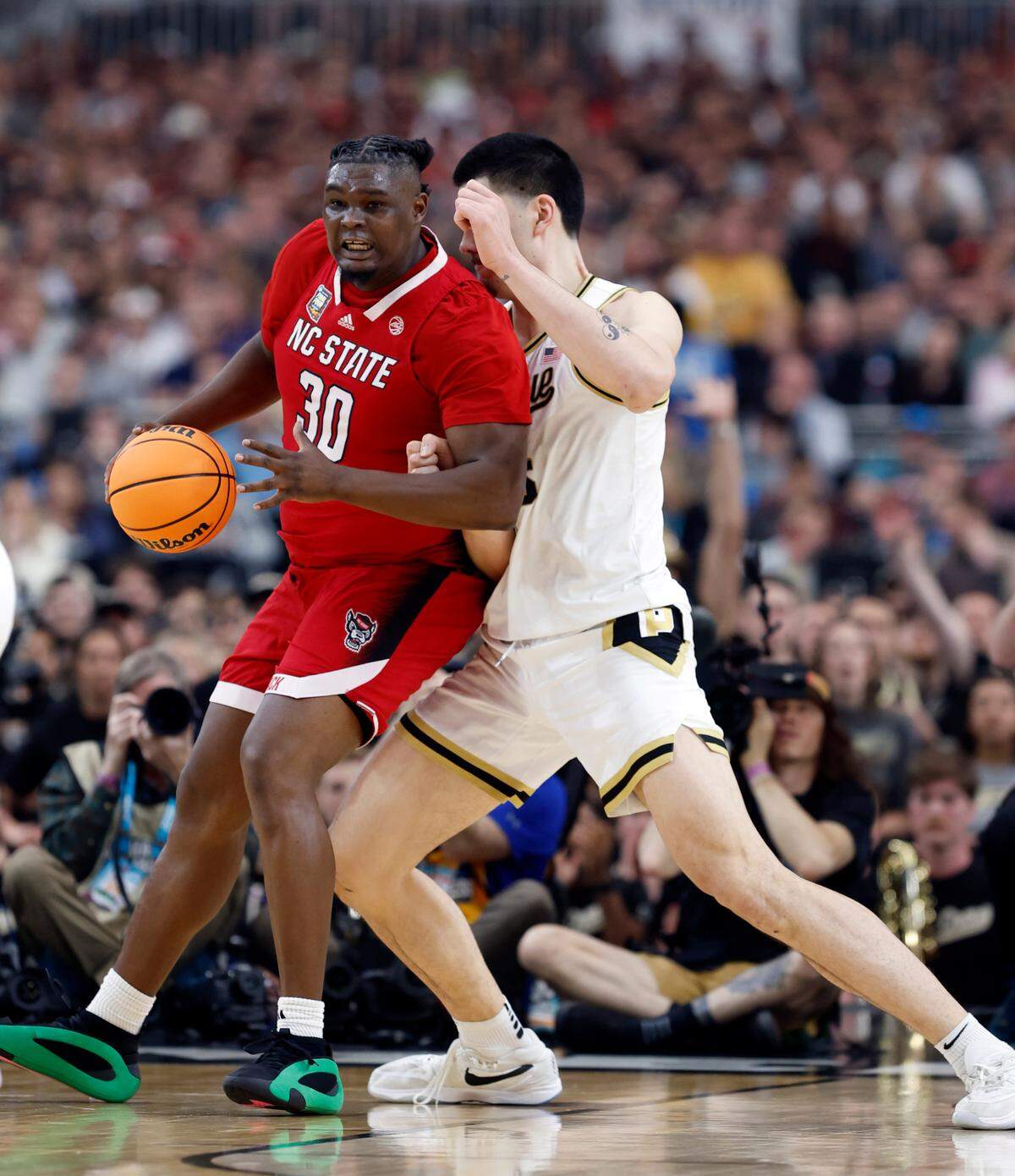 NC State’s DJ Burns tries to muscle to the basket against Purdue’s Zach Edey during the first half of their NCAA Final Four game.