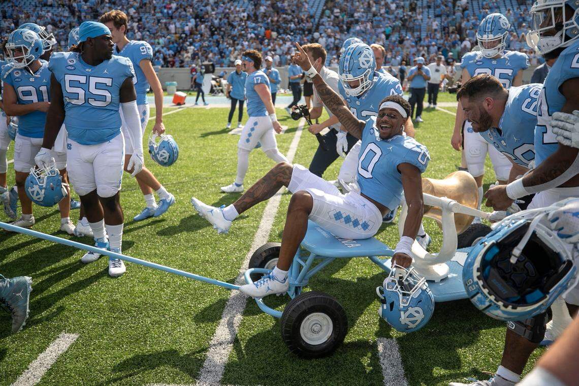 North Carolina’s Emery Simmons (0) rides the victory bell as the Tar Heels celebrate their 38-7 victory over Duke on Saturday, October 2, 2021 at Kenan Stadium in Chapel Hill, N.C.