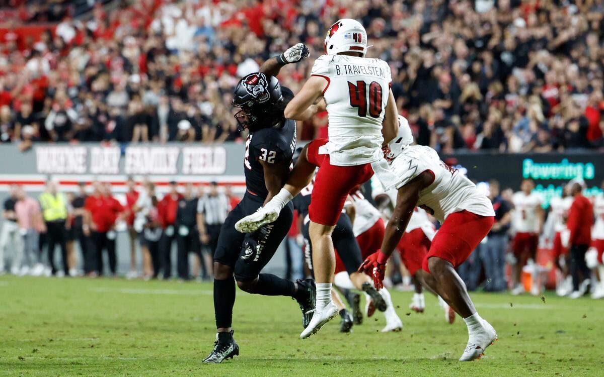N.C. State’s Jakolbe Baldwin is called for running into the kicker as Louisville’s Brock Travelstead (40) punts in the fourth quarter of Louisville’s 13-10 victory over N.C. State at Carter-Finley Stadium in Raleigh, N.C., Friday, Sept. 29, 2023.