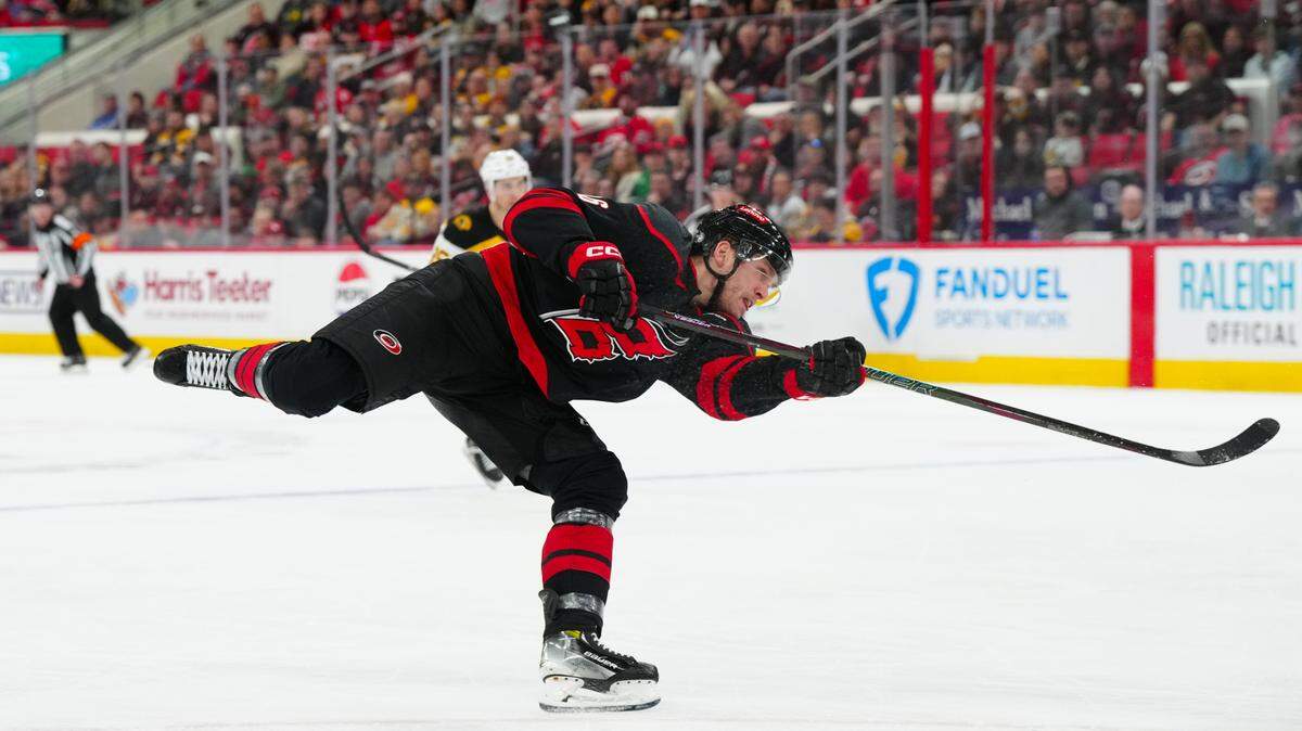 Mar 6, 2025; Raleigh, North Carolina, USA; Carolina Hurricanes right wing Mikko Rantanen (96) takes a shot against the Boston Bruins during the third period at Lenovo Center. Mandatory Credit: James Guillory-Imagn Images