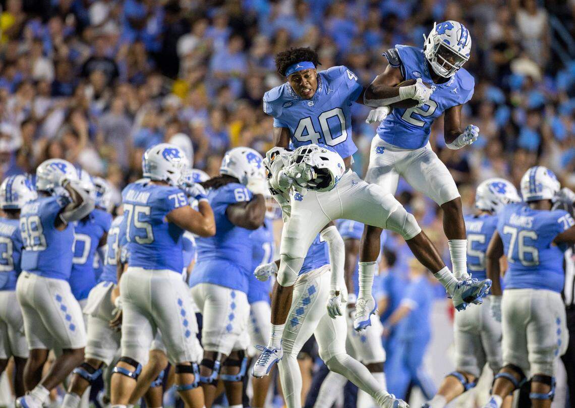 North Carolina’s Don Chapman (2) celebrates with teammate Tyler Thompson (40) with after intercepting a pass by Appalachian State quarterback Joey Aguilar (4) in the third quarter on Saturday September 9, 2023 at Kenan Stadium in Chapel Hill, N.C. 