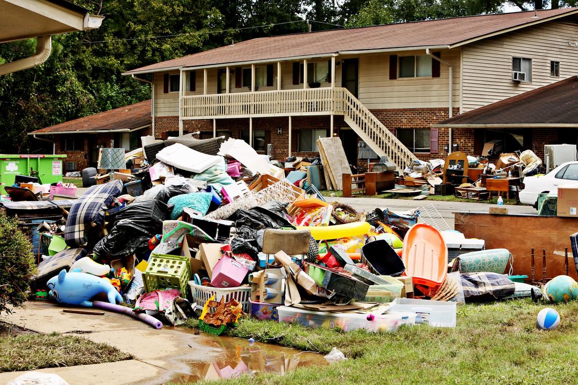 Soggy belongings are piled up outside of Camelot Village Condominiums off of Estes Drive in Chapel Hill on Tuesday, Sept. 18, 2018.  Many of the lower units were flooded by Bolin Creek yesterday.