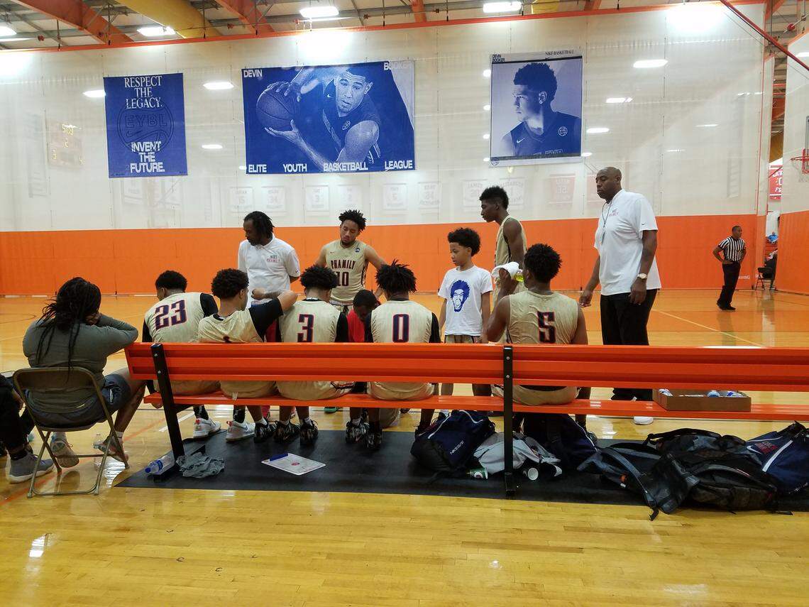 Martray Bagley, 8, interacts with Nike Phamily players, including his older brother Marcus Bagley (23), on the bench during a Nike Elite Youth Basketball League game at Hampton, Va., on May 26, 2018.