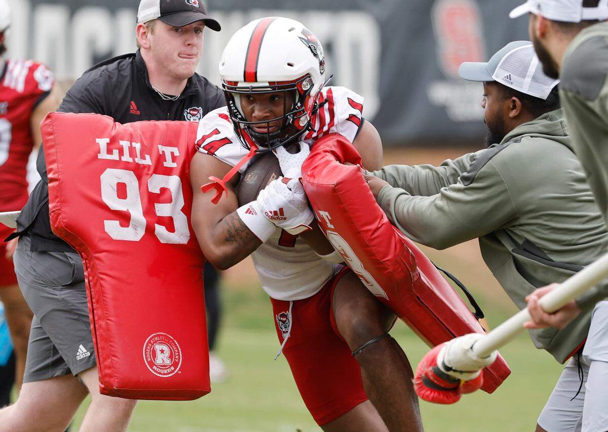 N.C. State cornerback Rente Hinton (14) runs a drill during the Wolfpack’s first spring practice in Raleigh, N.C., Wednesday, March 1, 2023.