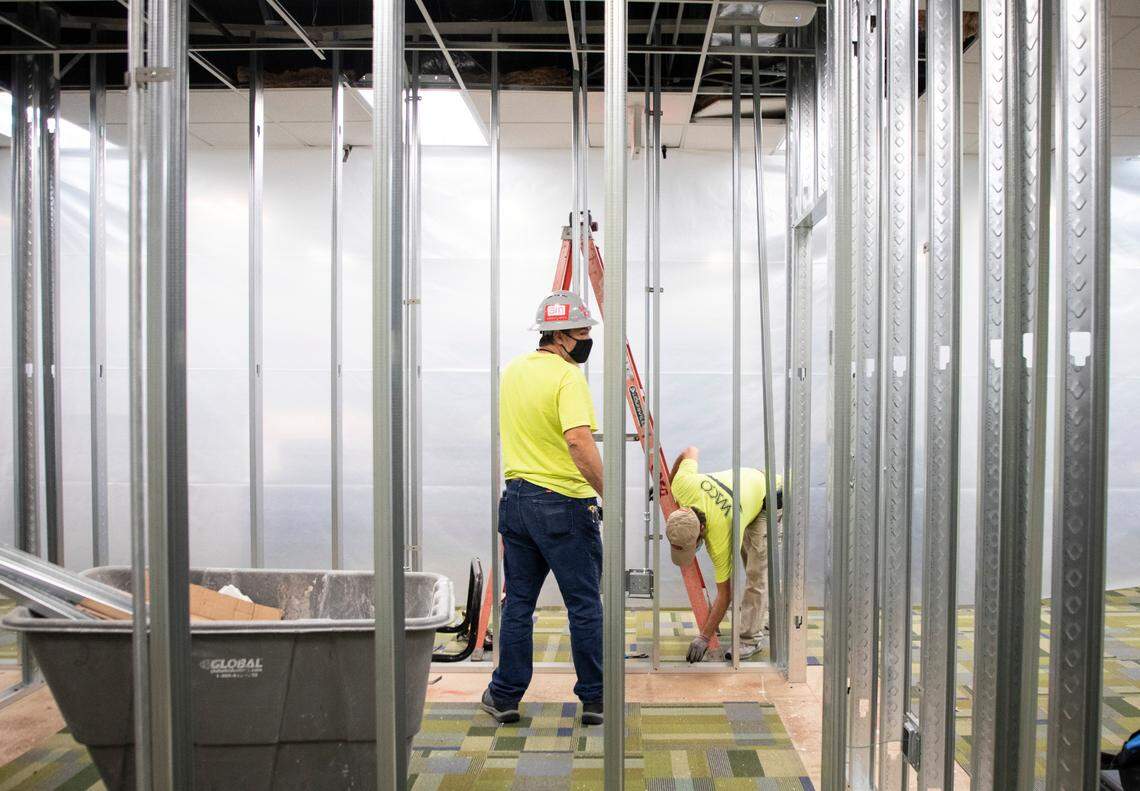 Workers assemble walls in an area that will soon be used as a forensic photography lab for crime scene analysis and offices for forensic managers in Raleigh, N.C. on Friday, Nov. 12, 2021.