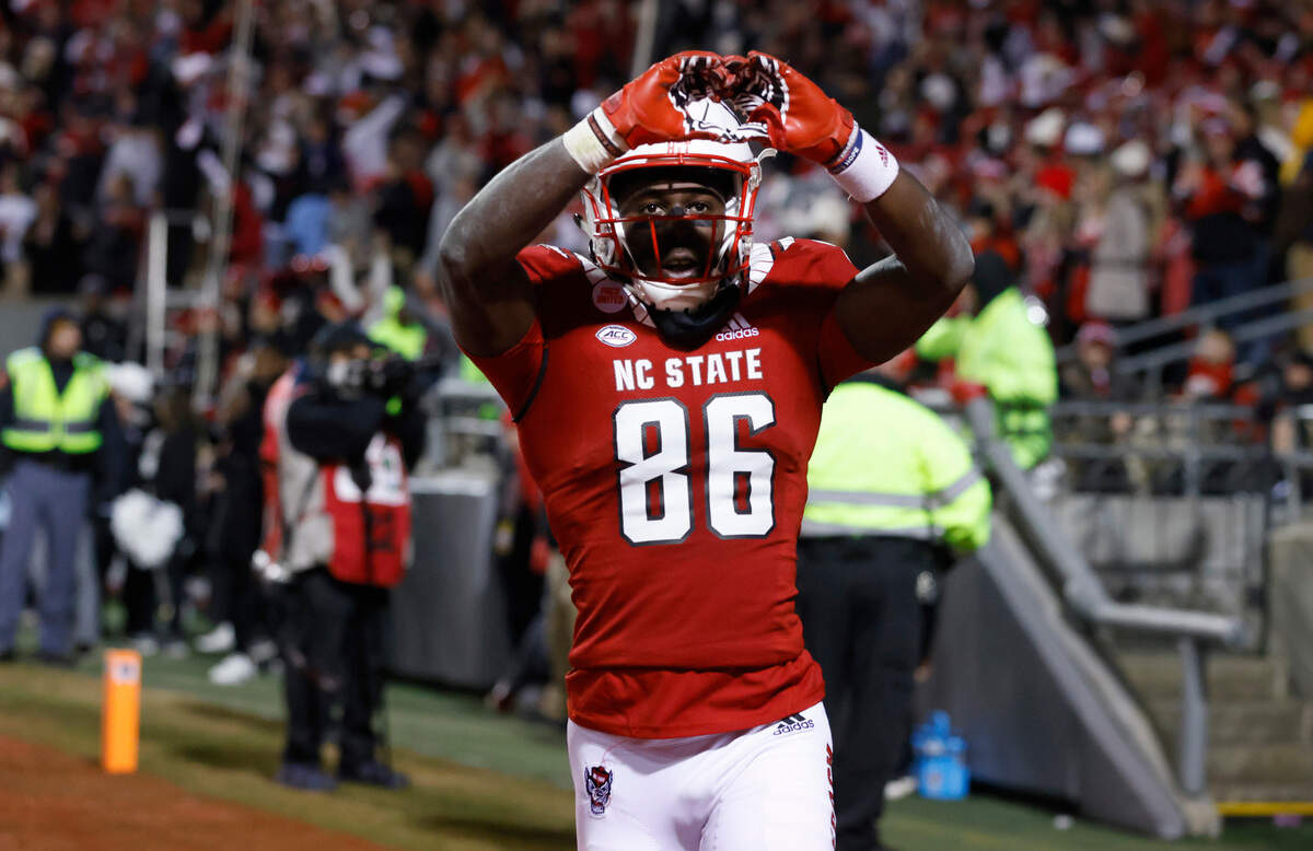 N.C. State wide receiver Emeka Emezie (86) celebrates after making what would be the game winning touchdown reception late in the second half of N.C. State’s 34-30 victory over UNC at Carter-Finley Stadium in Raleigh, N.C., Friday, November 26, 2021.