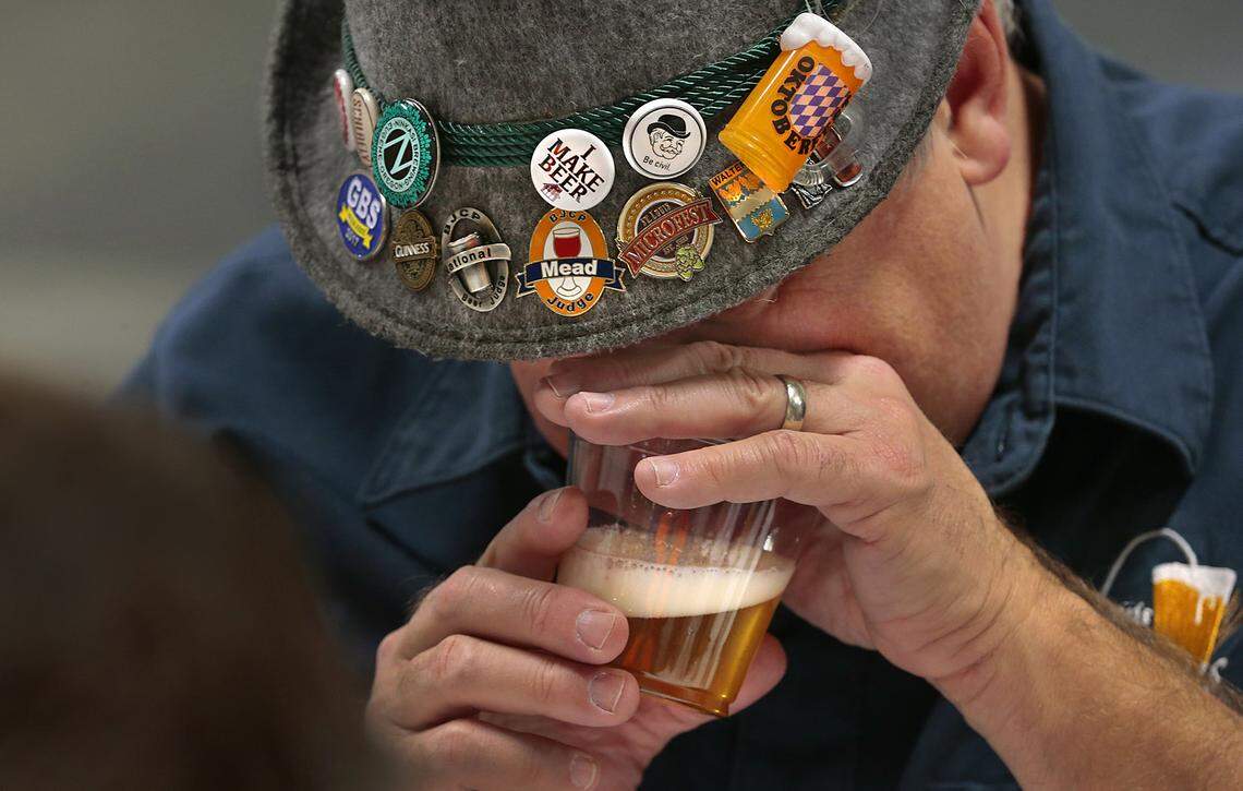 Mike Walters of St. Louis Brews judges the aroma of a light ale during the Happy Holidays Home-brew Competition in 2020. Judges work in two-person teams, evaluating the best in aroma, appearance, flavor and the defined weight or thickness of the beer.